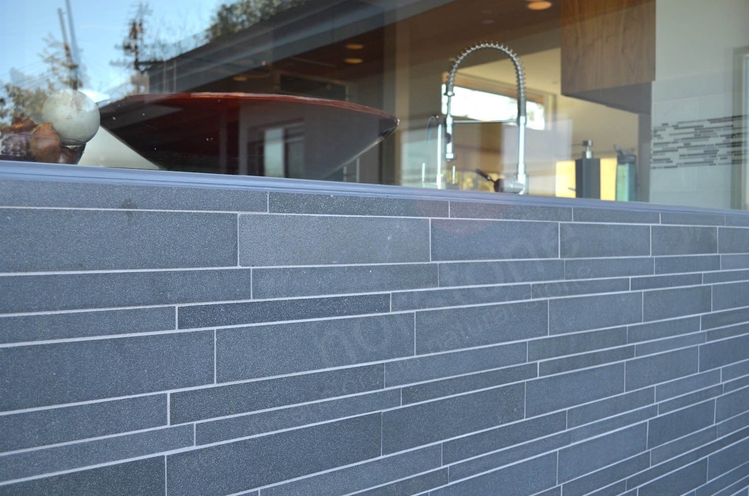 Norstone Lynia Tile in Grey installed with a light contrasting grout color on an outdoor feature wall